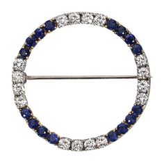 This is part of Chairish’s Fine Jewelry assortment.  Introducing our exquisite Vintage Diamond and Sapphire Circle Brooch, a true testament to timeless elegance and luxurious craftsmanship. This magnificent piece showcases a harmonious blend of 14 karat white and yellow gold, accentuated by dazzling diamonds and a captivating sapphire. At the heart of this brooch, a brilliant 1.25 carat diamond takes center stage, radiating brilliance and sophistication. Its mesmerizing facets reflect light from Platinum Brooches With Single Cut Diamonds In White Gold, White Gold Brooches With Single Cut Diamonds In Platinum, Classic Platinum Brooch With Brilliant Cut, Classic White Gold Brooch With Brilliant Cut, Fine Jewelry White Gold Brooch With Brilliant Cut, Platinum White Gold Fine Jewelry Brooch, Fine Jewelry White Gold Brooches With Brilliant Cut, Classic White Gold Brooches With 17 Jewels, Exquisite Round Brooch Jewelry