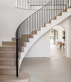 a spiral staircase in a house with white walls