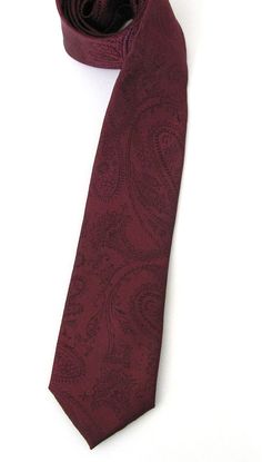 This trendy skinny tie is made of a 100% silk, all new material. It measures 58 long and 2 at the widest point. Classic Patterned Suit And Tie Accessories For Black Tie, Formal Patterned Paisley Suit And Tie Accessories, Classic Paisley Print Suit And Tie Accessories For Semi-formal, Elegant Semi-formal Ties With Paisley Print, Elegant Semi-formal Paisley Print Ties, Business Suit And Tie Accessories With Paisley Print, Patterned Fitted Ties For Business, Fitted Ties With Pocket Square For Black-tie Events, Semi-formal Standard Tie With Paisley Print