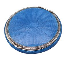 a round blue case with silver trim