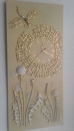 an intricately designed paper art piece with flowers and dragonflys on the wall