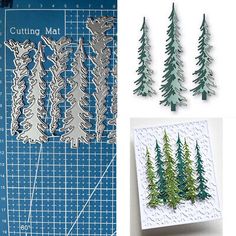 the cutting mat is next to some cut outs and pine trees