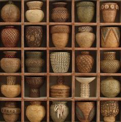 an assortment of vases in wooden boxes