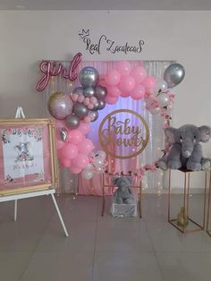 a baby shower with balloons and stuffed animals