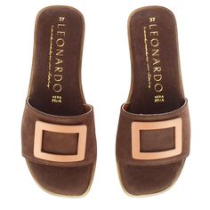 Suede leather slipper

Dark brown suede leather

Band with beige rectangular appliqué

Leather sole

Handmade in Italy Suede Slides With Leather Sole, Brown Suede Slip-on Slippers, Brown Suede Slide Sandals, Brown Slip-on Slide Mules, Suede Slip-on Slides With Suede Lining, Brown Leather Sole Slides, Slip-on Fit, Brown Suede Open Toe Slides, Brown Slip-on Slides, Brown Slip-on Open Toe Slippers