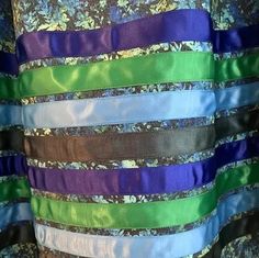 a woman's dress with multicolored ribbons on it