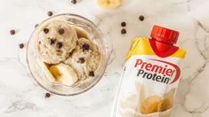 an ice cream and cookies in a glass bowl next to a bag of pretzel protein