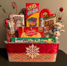 a christmas gift basket filled with candy and snacks