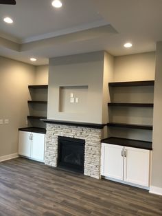 empty living room with fireplace and built in shelving