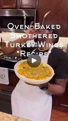 a man holding a bowl of food in front of his face with the words oven baked smothered turkey wings recipe