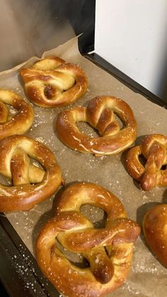 freshly baked pretzels sitting on top of a baking sheet