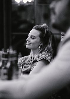 a black and white photo of a woman at a bar