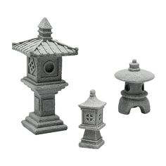 three small stone lanterns and a birdhouse on a white background, with one lantern in the foreground