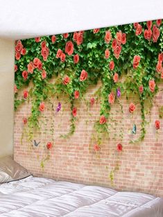 a bedroom with a brick wall and flowers on the wall, along with a bed