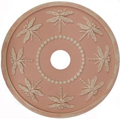 a decorative pink plate with white flowers on it