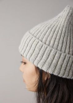 a woman wearing a gray knitted hat