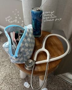 a wooden table topped with medical supplies and a can on top of it next to a chair