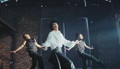 the group of young men are performing on stage