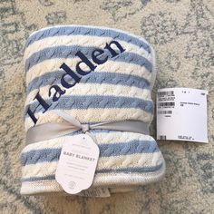 a baby blanket with the name haddler on it next to a price tag