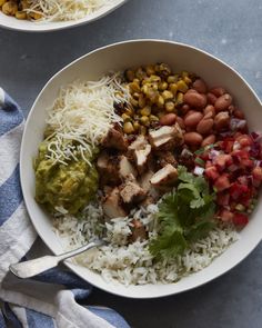 a white bowl filled with rice, beans and guacamole