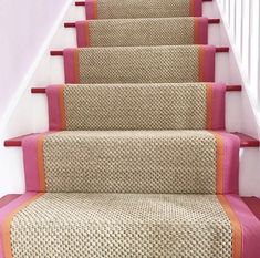 a set of stairs with pink and beige carpet