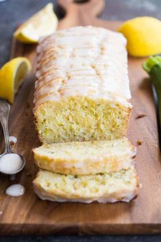 a loaf of lemon bread sitting on top of a wooden cutting board