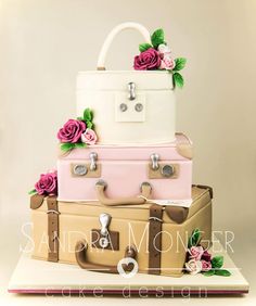 three suitcases stacked on top of each other with pink roses and green leaves around them