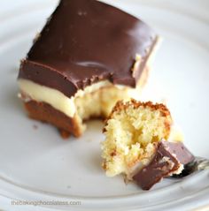 a half eaten piece of cake sitting on top of a white plate