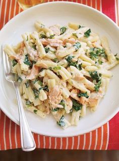 a white plate topped with pasta and chicken