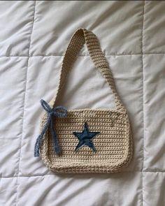 a crocheted bag with a blue star on it