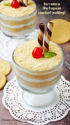 two desserts with strawberries on top in small glass dishes next to each other