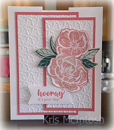 a close up of a greeting card with flowers on the front and bottom, in pink