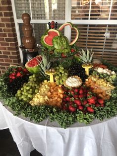 a table topped with lots of different types of fruits and veggies on top of it