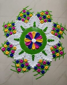 this is an image of a colorful rangolite design on the floor for diwaling