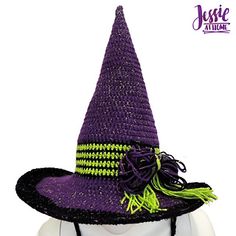 a purple and green witches hat on top of a mannequin's head