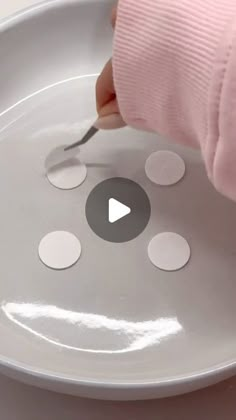 a person is cutting circles on a white plate