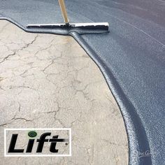 a person with a mop on the side of a road next to a sign that says lift