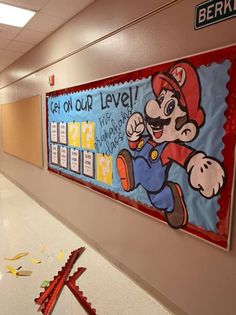 a bulletin board with mario on it in an office hallway that has been decorated by students