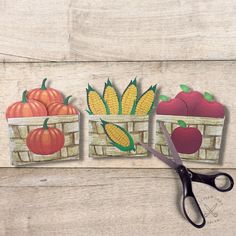 the paper cut outs have fruit and vegetables in them, along with a pair of scissors