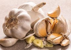 an assortment of garlic on a white surface