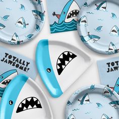 there are plates with shark designs on them and napkins that say totally jawome