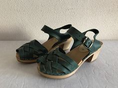 "Swedish Clogs Women Shoes Green Wooden Clogs Leather Shoes Eco friendly Wooden Sandals Made in Sweden 36 Size Stamped size: EUR 37 Length: 9 1/4\"/ 23.5 cm  Heel height: 2.5\"/ 6.5 cm Condition: Great Vintage Condition Made in Sweden N.B. Color may slightly differ from picture SHIPPING * Items are shipped 1 - 3 business days after receiving the payment. * I ship from Europe, so please allow 2 to 3 weeks for the package to arrive if you live overseas. * Europe 5 - 10 business days. 37" Closed Toe Beach Clogs With Buckle Closure, Beach Clogs With Buckle Closure And Round Toe, Summer Green Mules With Wooden Heel, Beach Clogs With Heel Strap, Green Clogs With Wooden Heel For Spring, Spring Green Clogs With Wooden Heel, Green Casual Mules With Wooden Heel, Casual Green Mules With Wooden Heel, Green Closed Toe Clogs For Summer