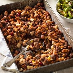 a casserole dish with meat and vegetables on the side, ready to be eaten