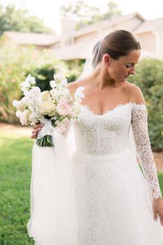 a woman in a wedding dress holding a bouquet