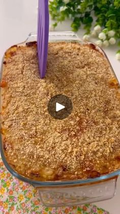 a casserole dish with a purple fork sticking out of it's top