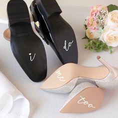 two pairs of shoes with the bride's names on them and flowers in the background