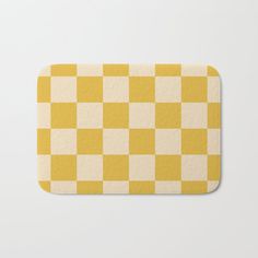 a yellow and white checkered bath mat