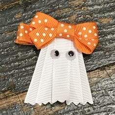 an orange and white paper ghost with polka dots on it