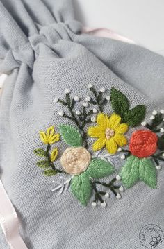 a drawstring bag with some flowers on it