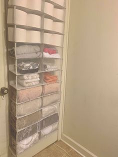 an organized closet is shown with towels and other items in it's storage bins